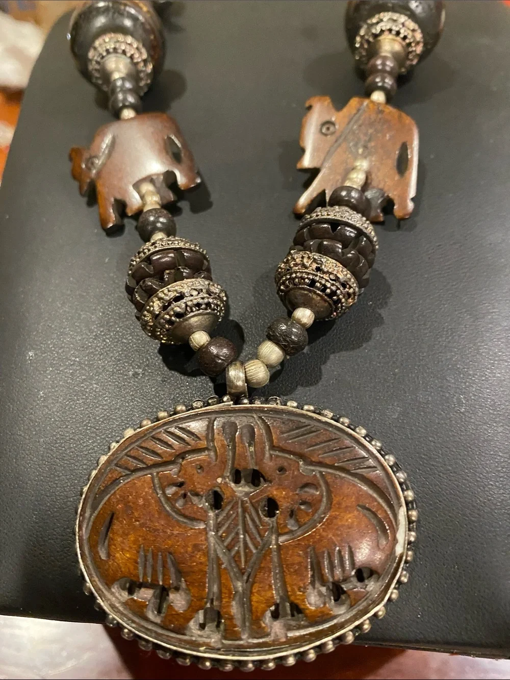 Handcrafted Elephant Pendant Necklace - Brown. Small elephants are bone.